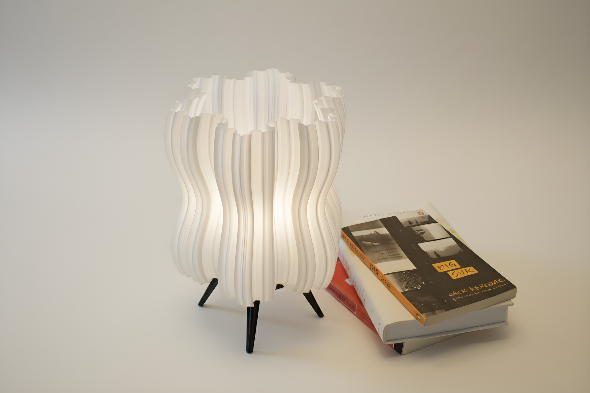 Modern Niyebe lamp with wavy design next to a book on a plain background
